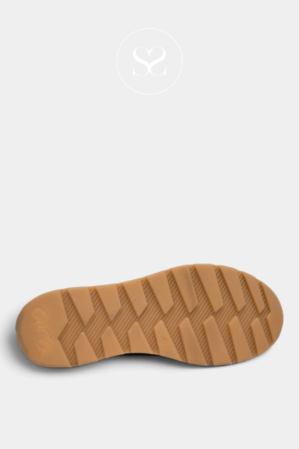A close-up of a tan rubber shoe sole with a textured tread pattern, shown against a light gray background with a faint circular logo at the top.