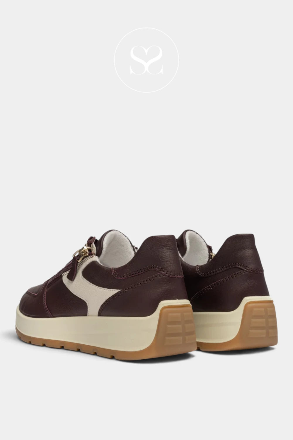 A pair of dark brown leather low-top sneakers with cream-colored side stripes and a thick beige and brown platform sole, shown from a rear three-quarter angle on a light gray background.
