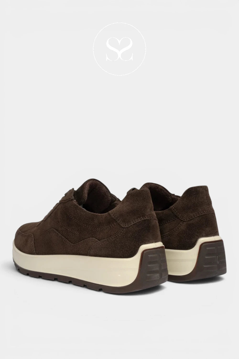 A pair of dark brown suede low-top sneakers with thick cream-colored midsoles and dark brown outsoles, shown from a rear three-quarter angle on a light gray background.