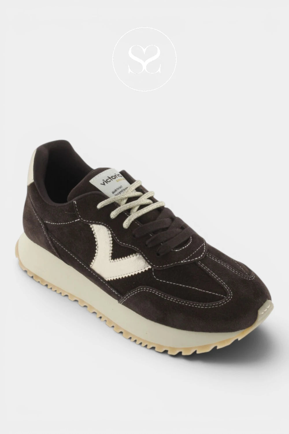 A dark brown suede sneaker with cream-colored accents, including the V logo on the side, laces, and midsole, shown against a light gray background.