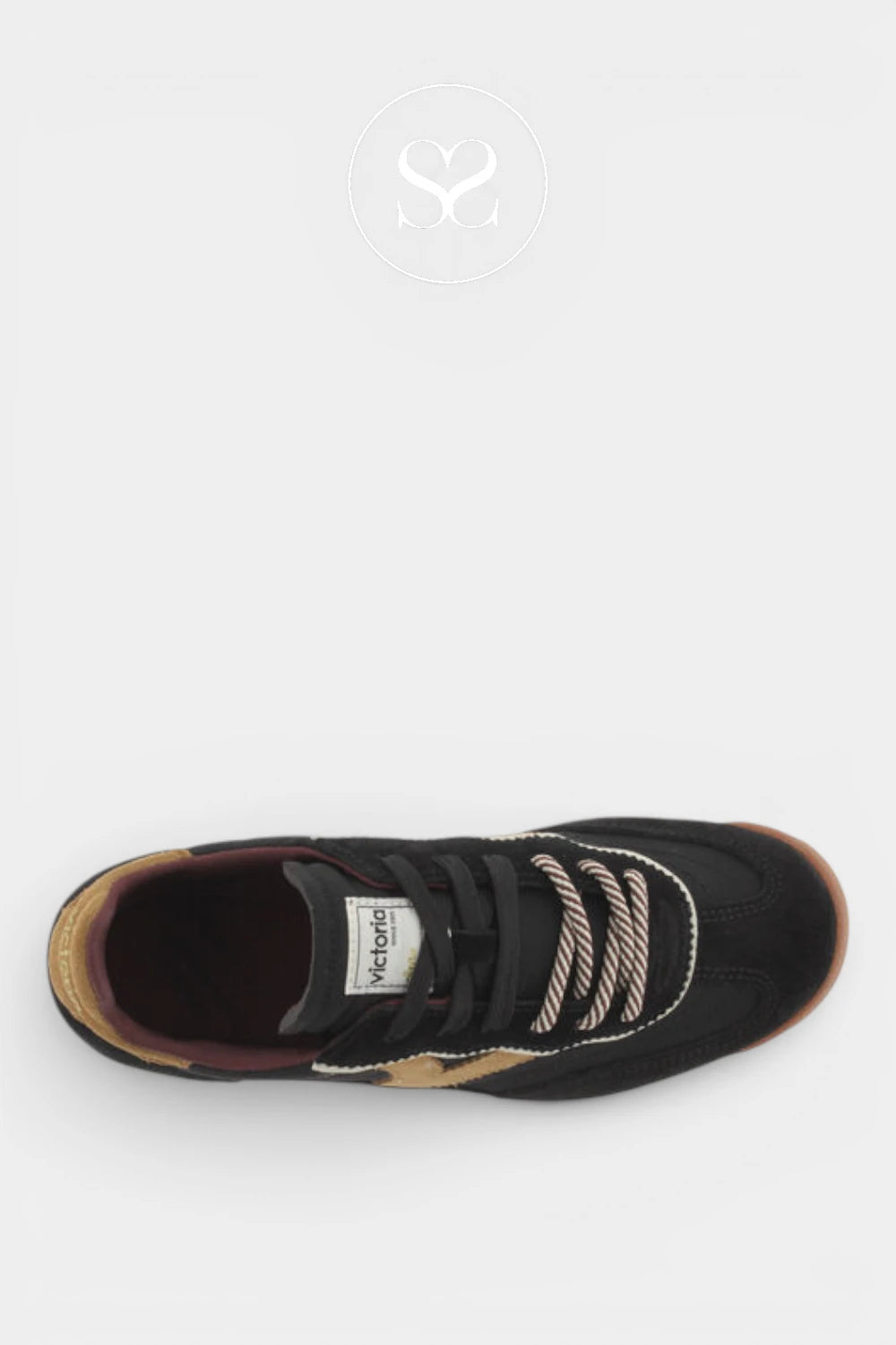 A black low-top sneaker by Michael Jordan, featuring black suede and mesh uppers, black laces with a white and black striped accent, a white tongue label, and a brown gum sole, shown from a top-down view on a light gray background.