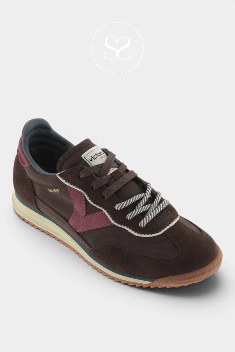 A single vintage-style low-top sneaker by Wels, shown from a three-quarters angle on a light gray background. The shoe features dark brown suede and leather panels, a dusty rose/magenta star-shaped side accent, white contrast stitching, and a beige midsole with a gum outsole.