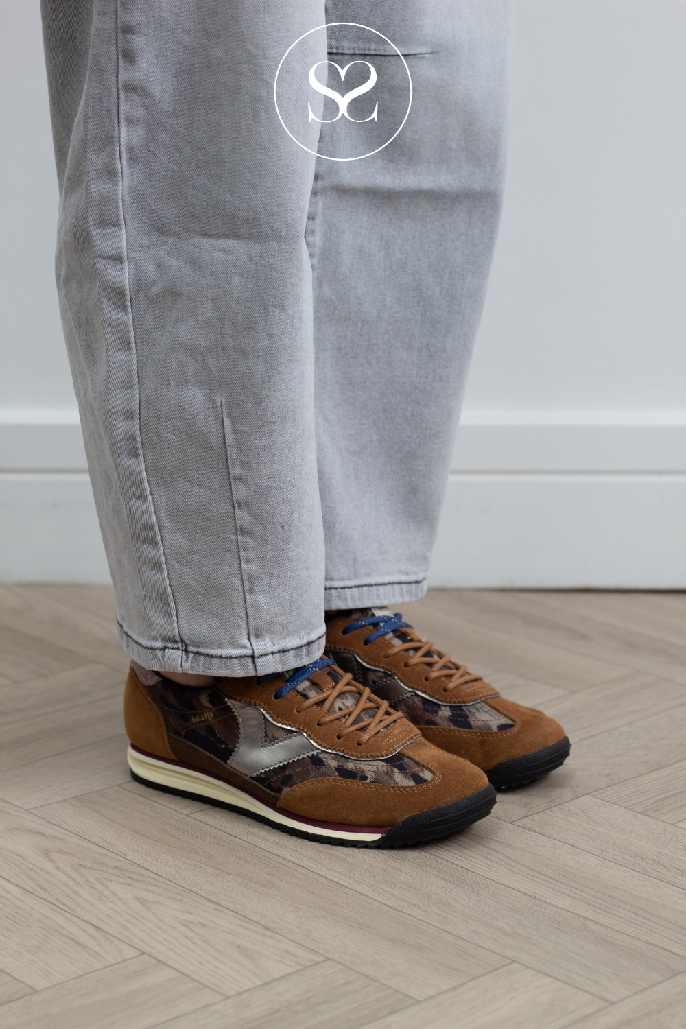 Victoria trainer pairs tan leather with a metallic silver V panel and leopard print detailing, finished with a pop of pink patent leather on the heel cap