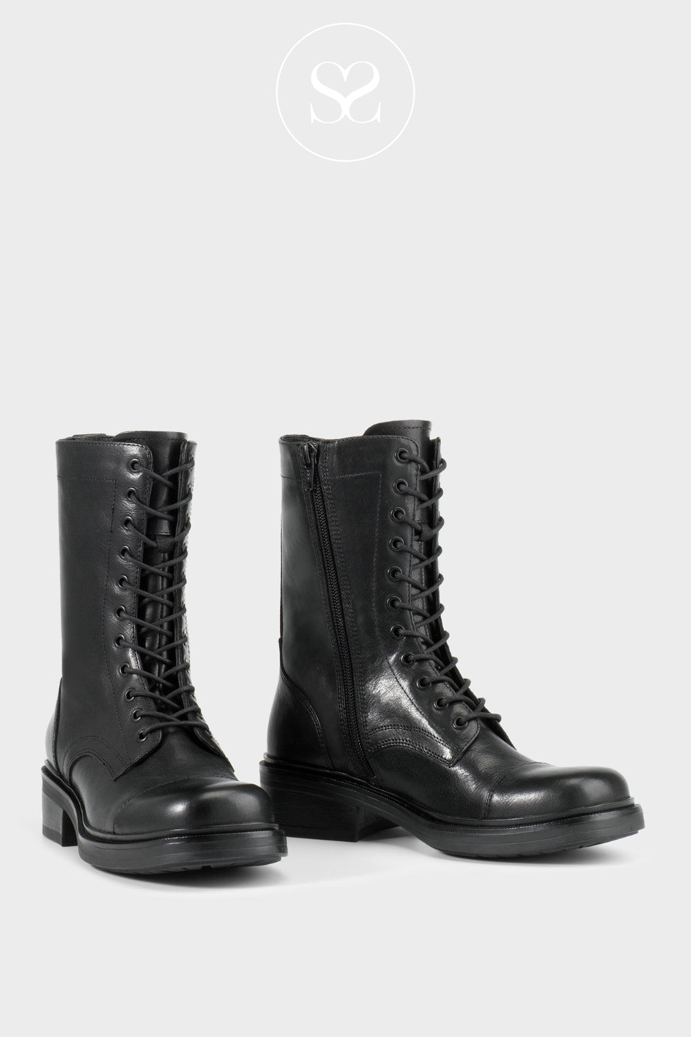 Pair of Vagabond black leather boots with laces for women on a light grey background