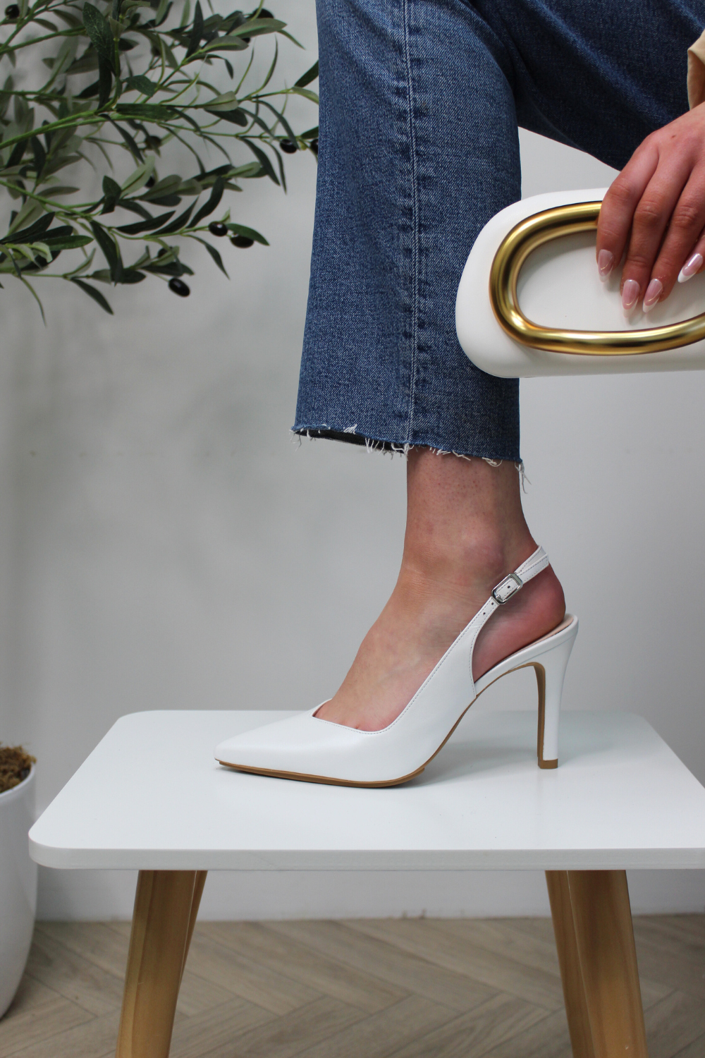 Lodi white leather pointed toe slingback high heels with adjustable ankle strap and v-cut.