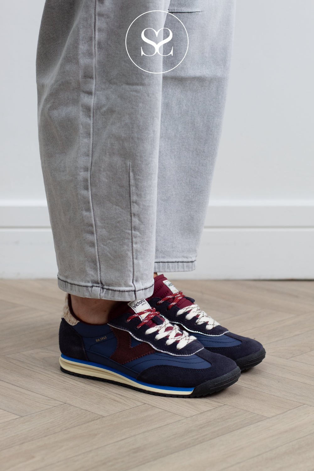 Victoria trainer combines a navy nylon and suede upper with a chocolate brown suede V panel and an animal print detail on the heel tab, designed for everyday wear around town.