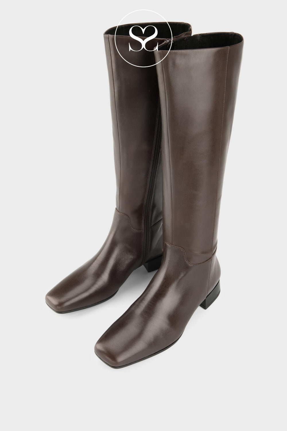 A pair of Vagabond dark brown leather knee-high boots with square toes and low block heels, shown on a light gray background with a watermark logo at the top.