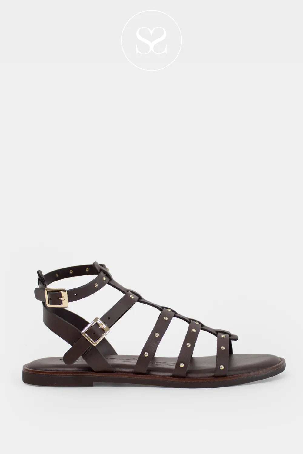 Brown leather gladiator style sandals with gold studs and double adjustable straps. Flat sandals with cushioned insole.