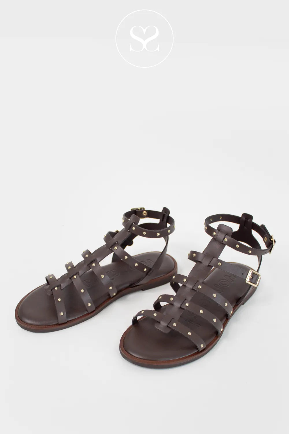 Chocolate brown flat sandals. Gold hardware and gladiator style studding.