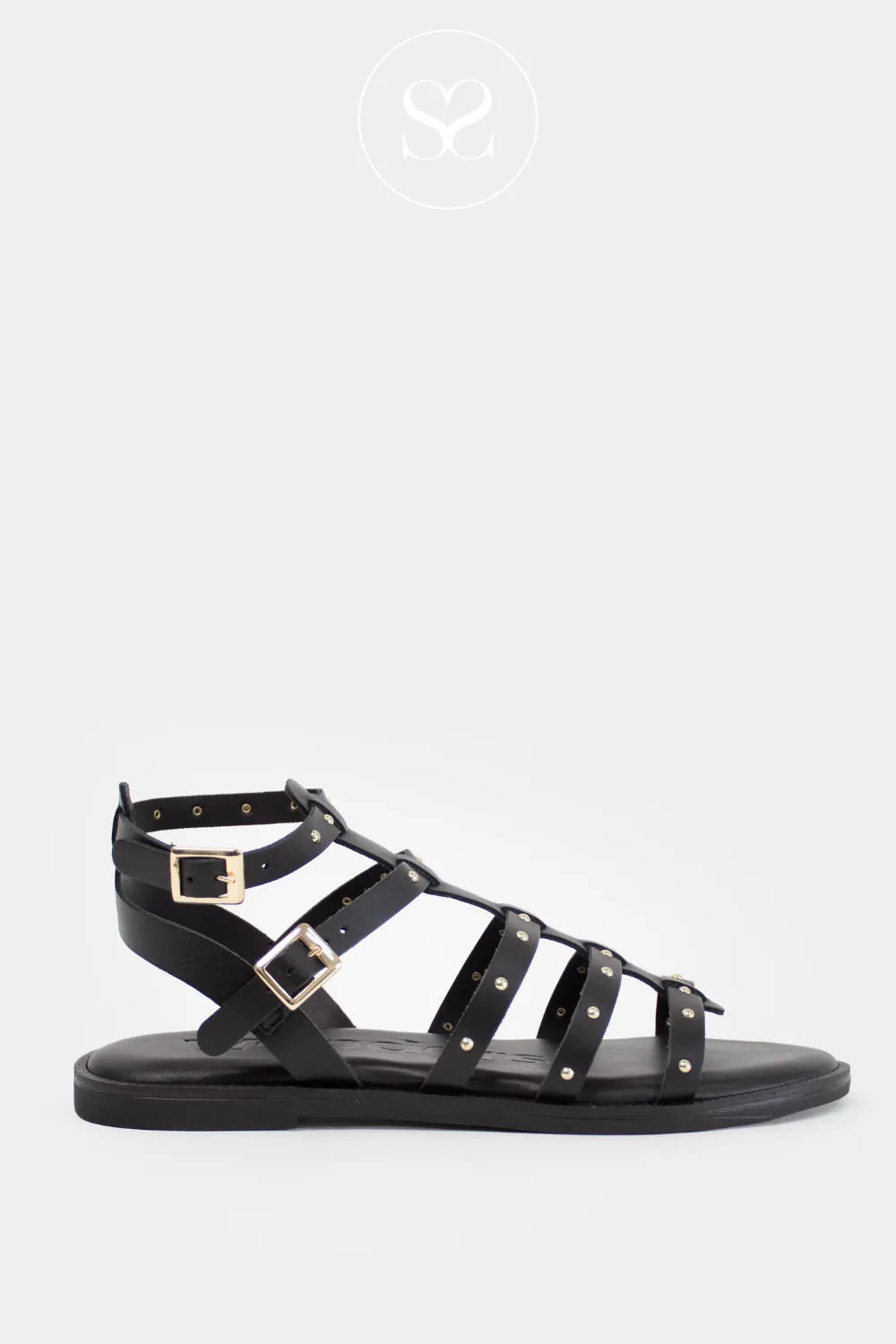 Wonders black leather gladiator sandals with gold studs and adjustable ankle straps. Soft cushioned sole. Flat gladiator style sandals
