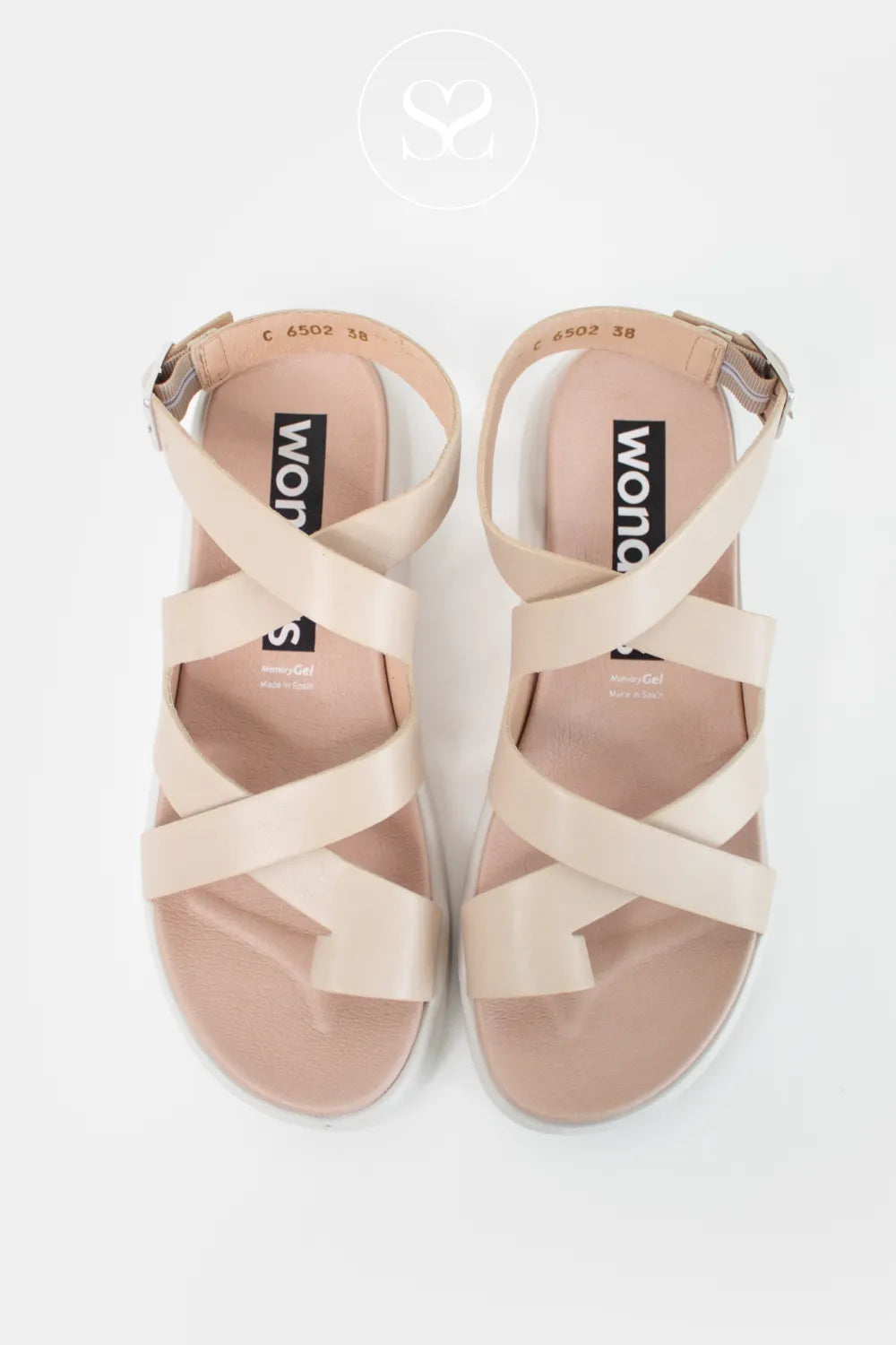 Nude criss cross strap summer sandals with adjustable ankle strap and toe post. Comfortable lightweight leather sandals.