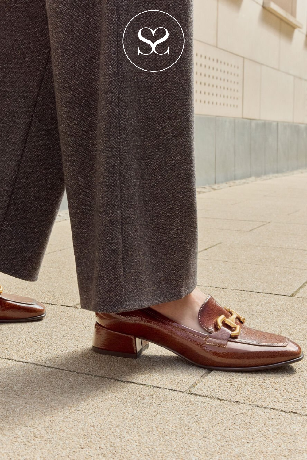 Slip on brown patent shoes. Gold chain detail. Low block heel. Square toe shoes. Leather lined.