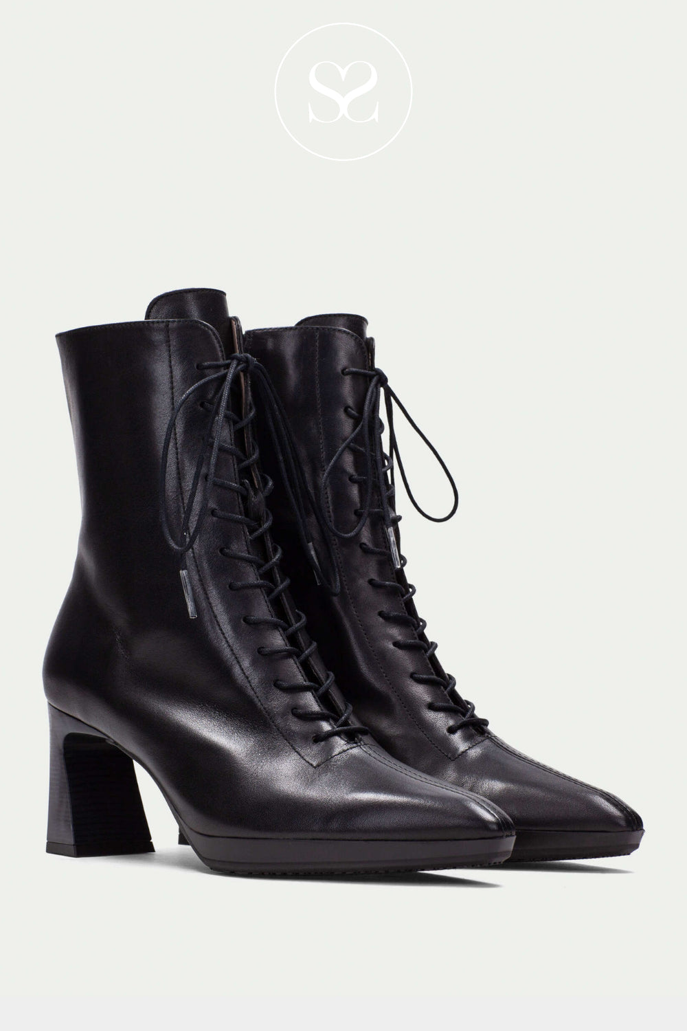 Pair of women's black leather boots with lace up front, block heel and pointed toe