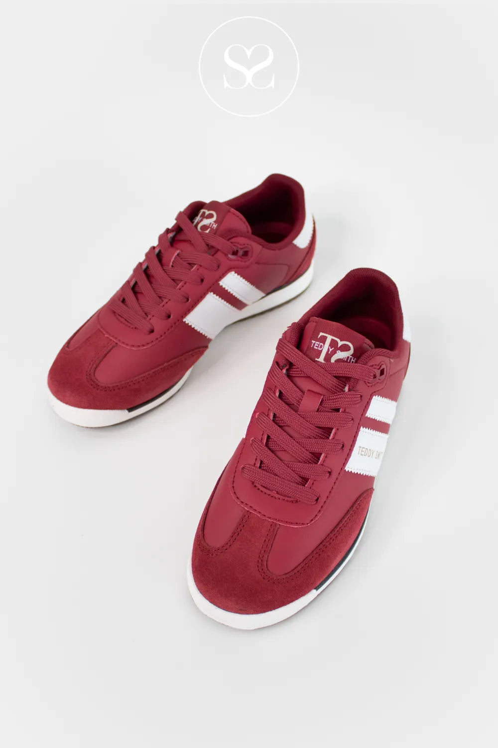 Red sneakers with white accents on a light grey background - Ireland