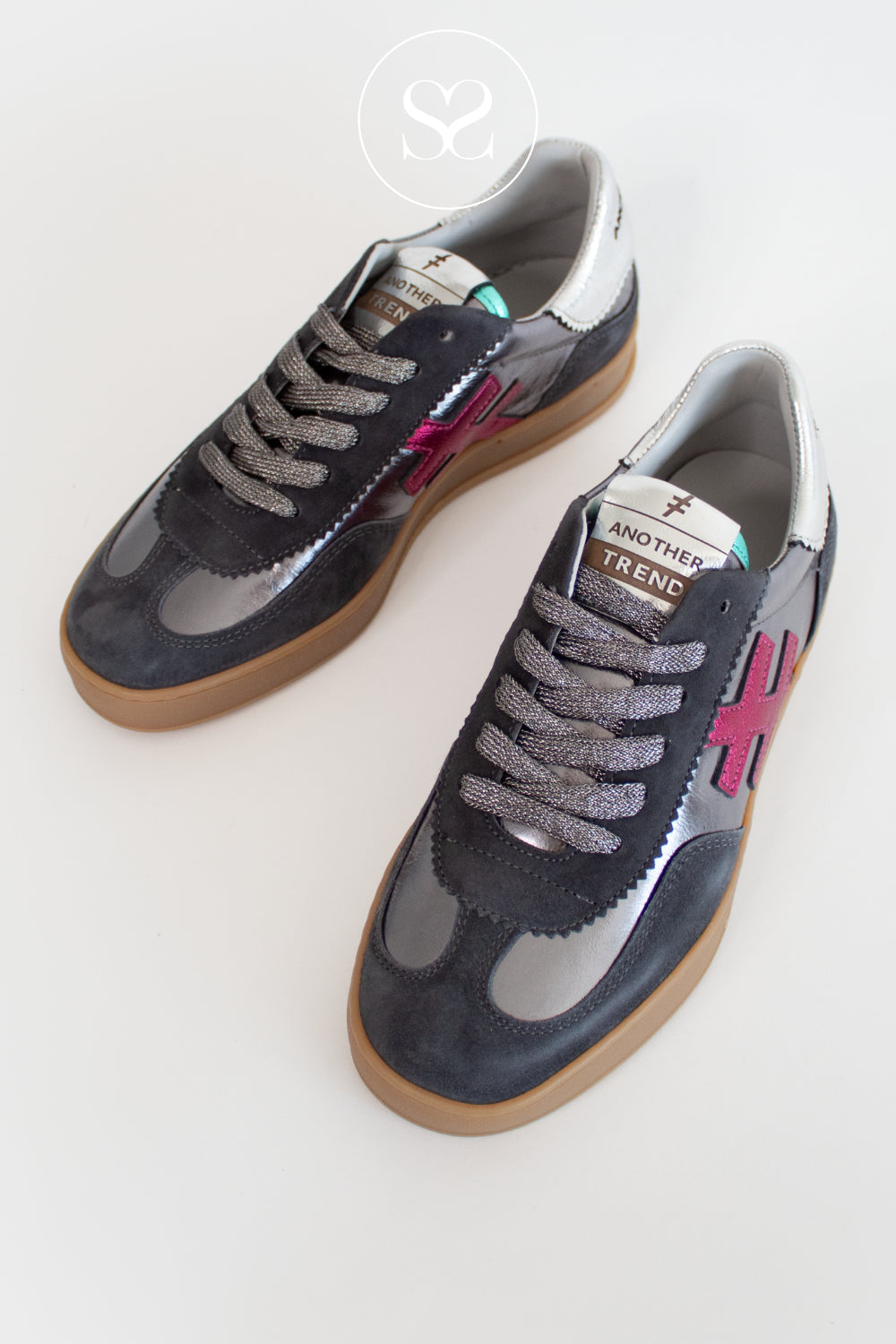 Pair of gray sneakers with pink accents on a white background