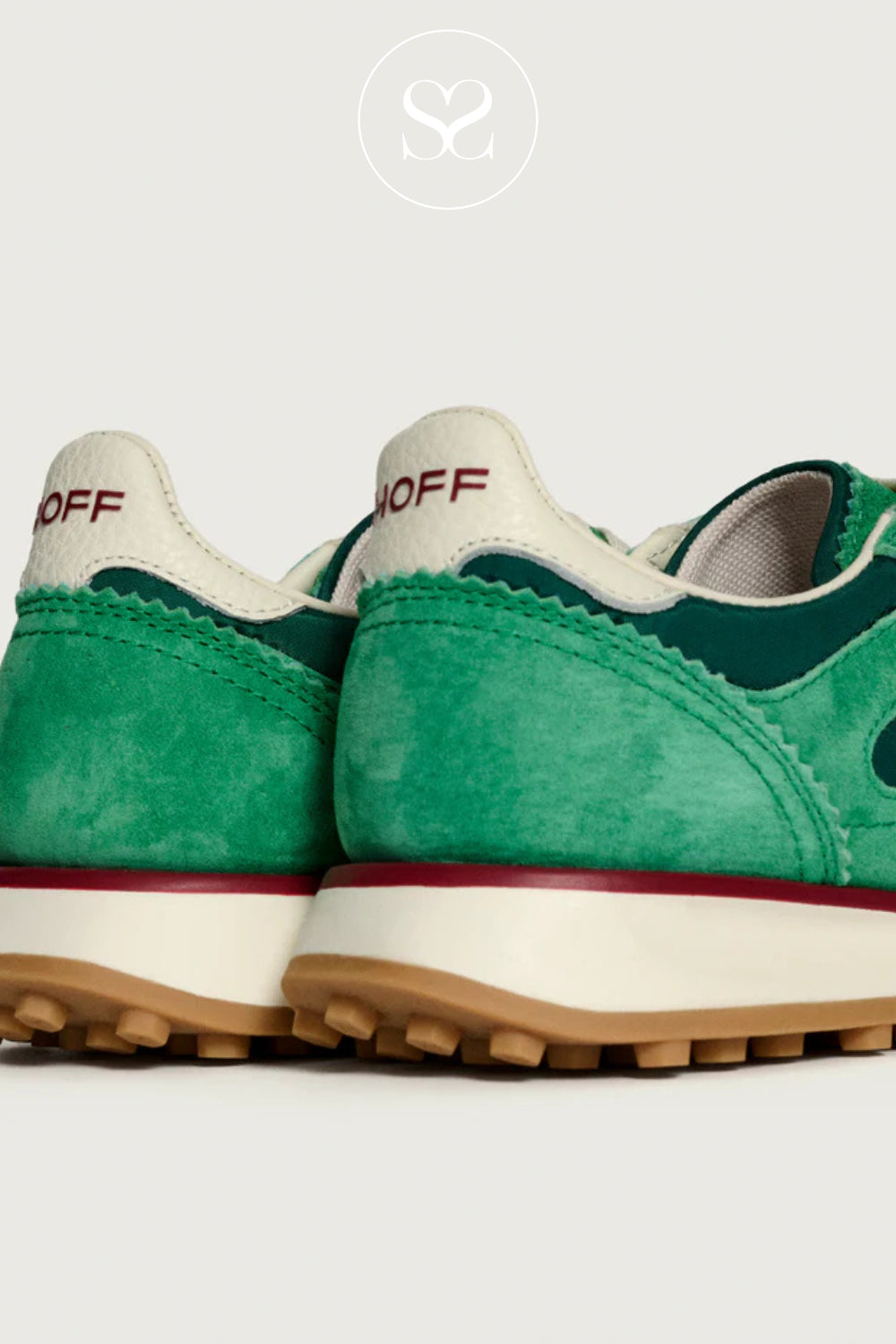 Green sneakers with white soles and red accents for women on a white background