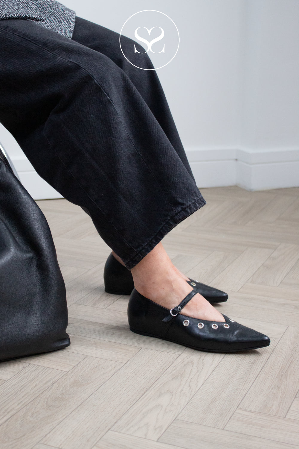 woman wearing black wonders pointed toe flats with silver stud details - wonders shoes in Ireland