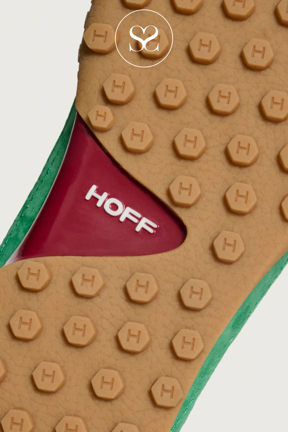 Close-up of a women's trainers sole with 'HOFF' branding and hexagonal pattern.