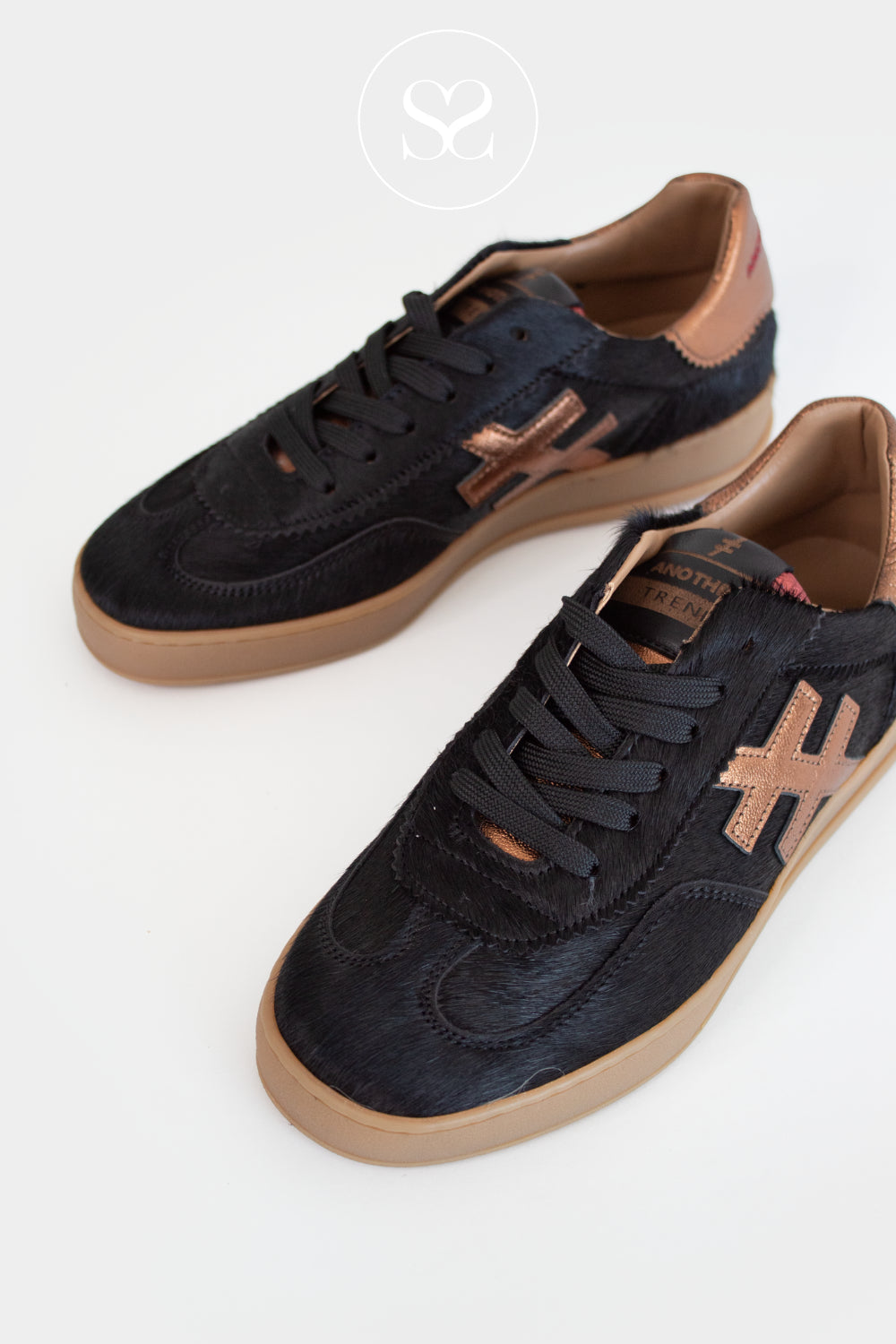 Black sneakers with brown accents on a white background