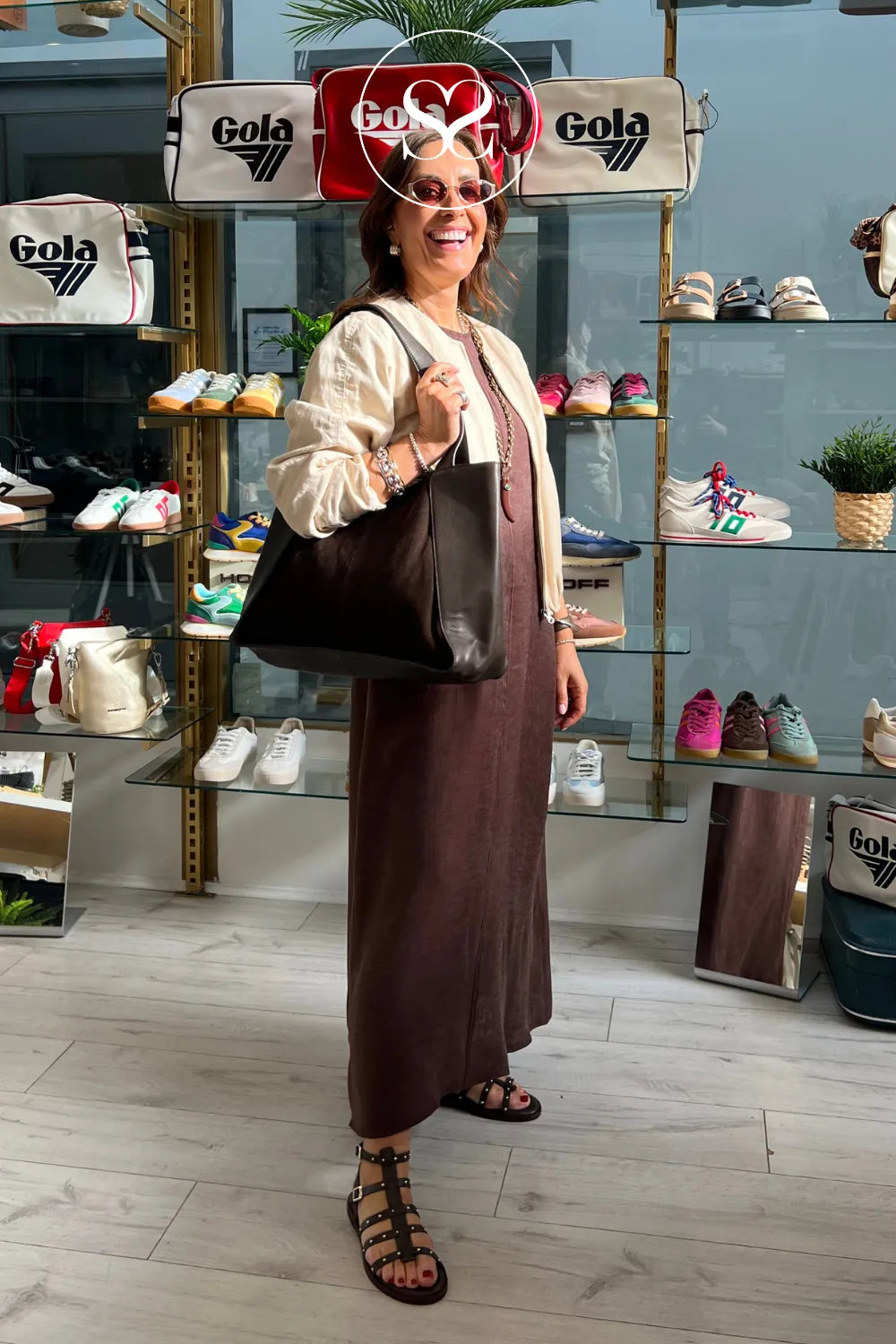 Woman wearing chocolate brown gladiator sandals from Wonders