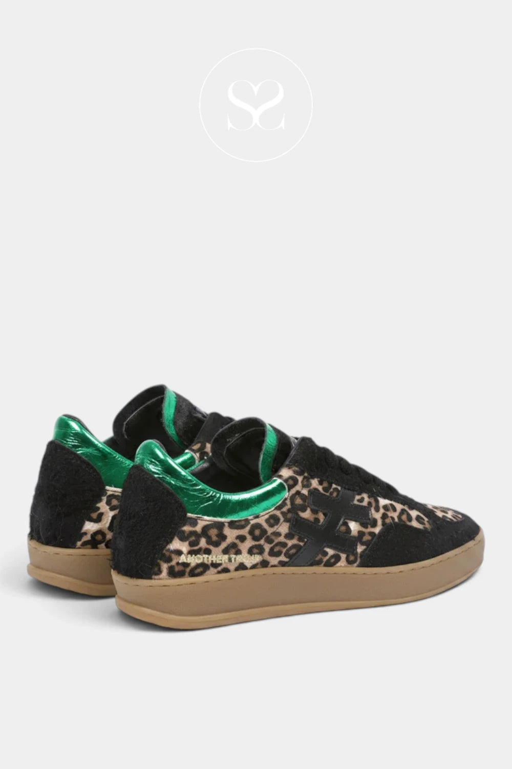 A pair of low-top sneakers featuring a leopard print pattern on the toe box, black suede panels, a metallic green heel tab, and a brown gum sole From Another Trend in Ireland