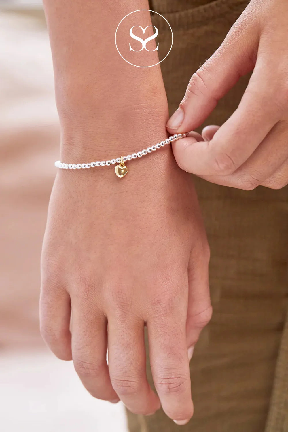 ESTELLA BARTLETT SIENNA PUFFED HEART BRACELET EBB6532G Silver-plated beading with a gold-plated heart charm