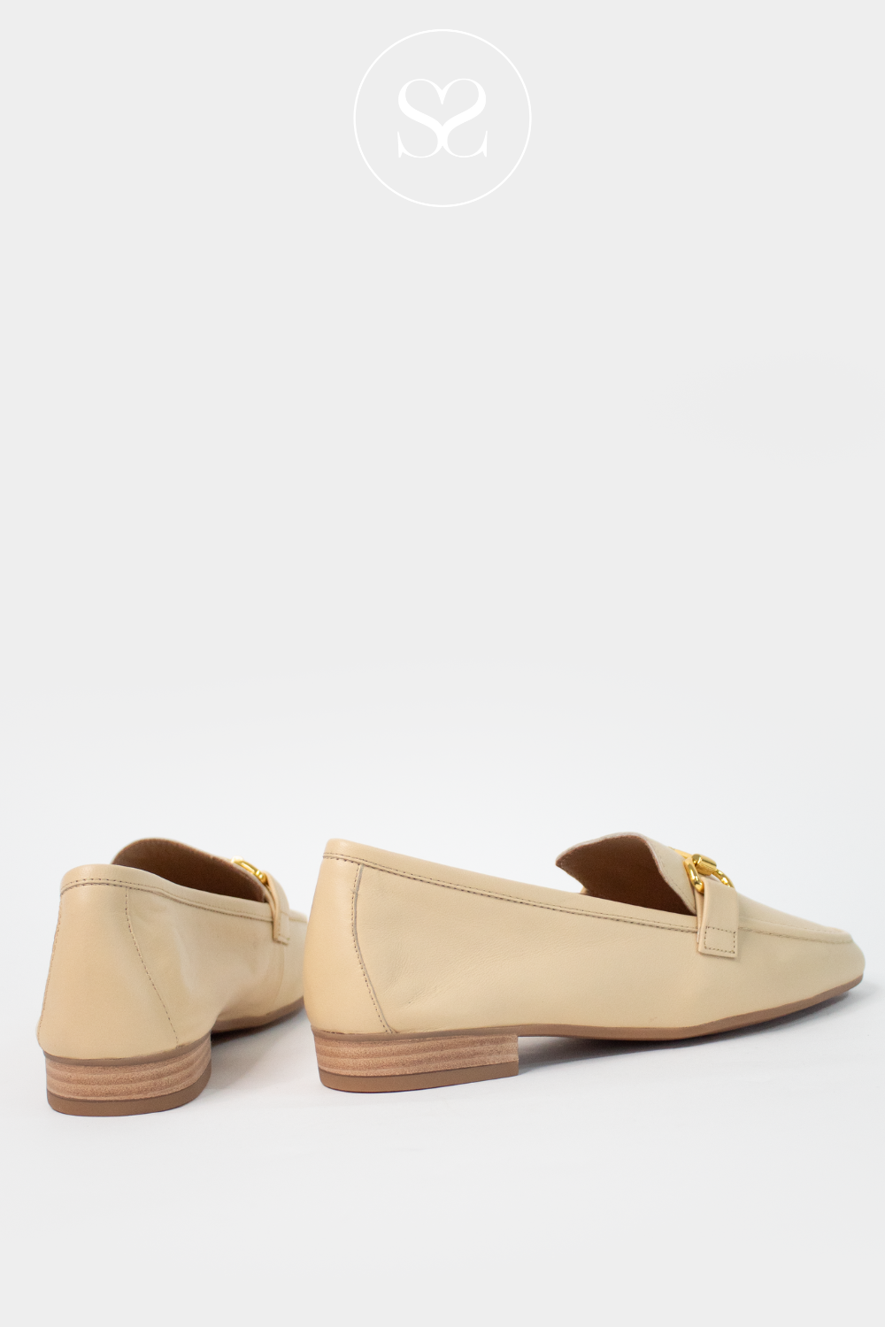 Unisa spanish leather loafers. slip on shoe in butter yellow with gold chain feature and very low block heel sole. Flat shoe. Slip on loafers