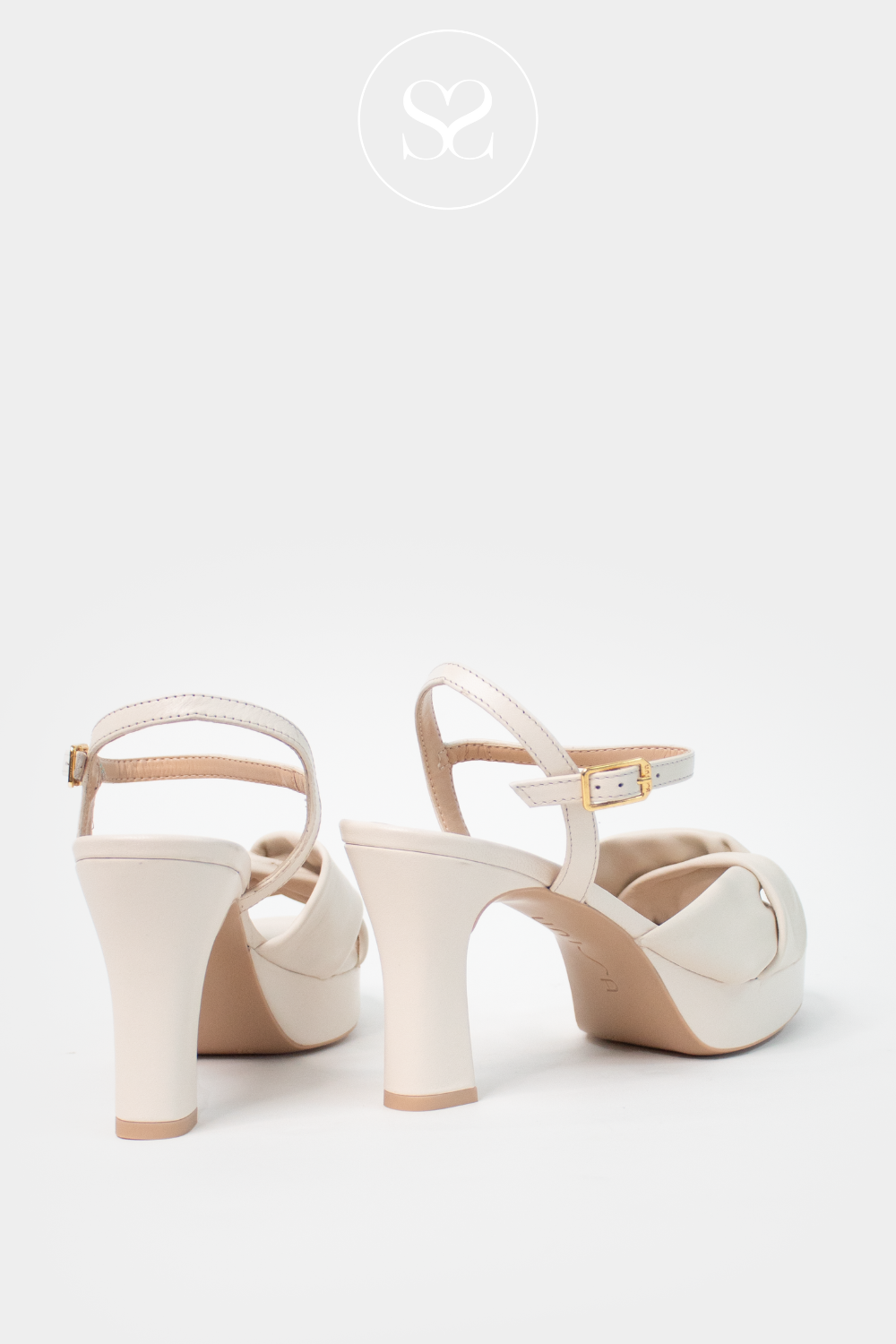 Unisa Onoa cream leather platform block heels with adjustable ankle strap and knotted criss cross strap across the foot.