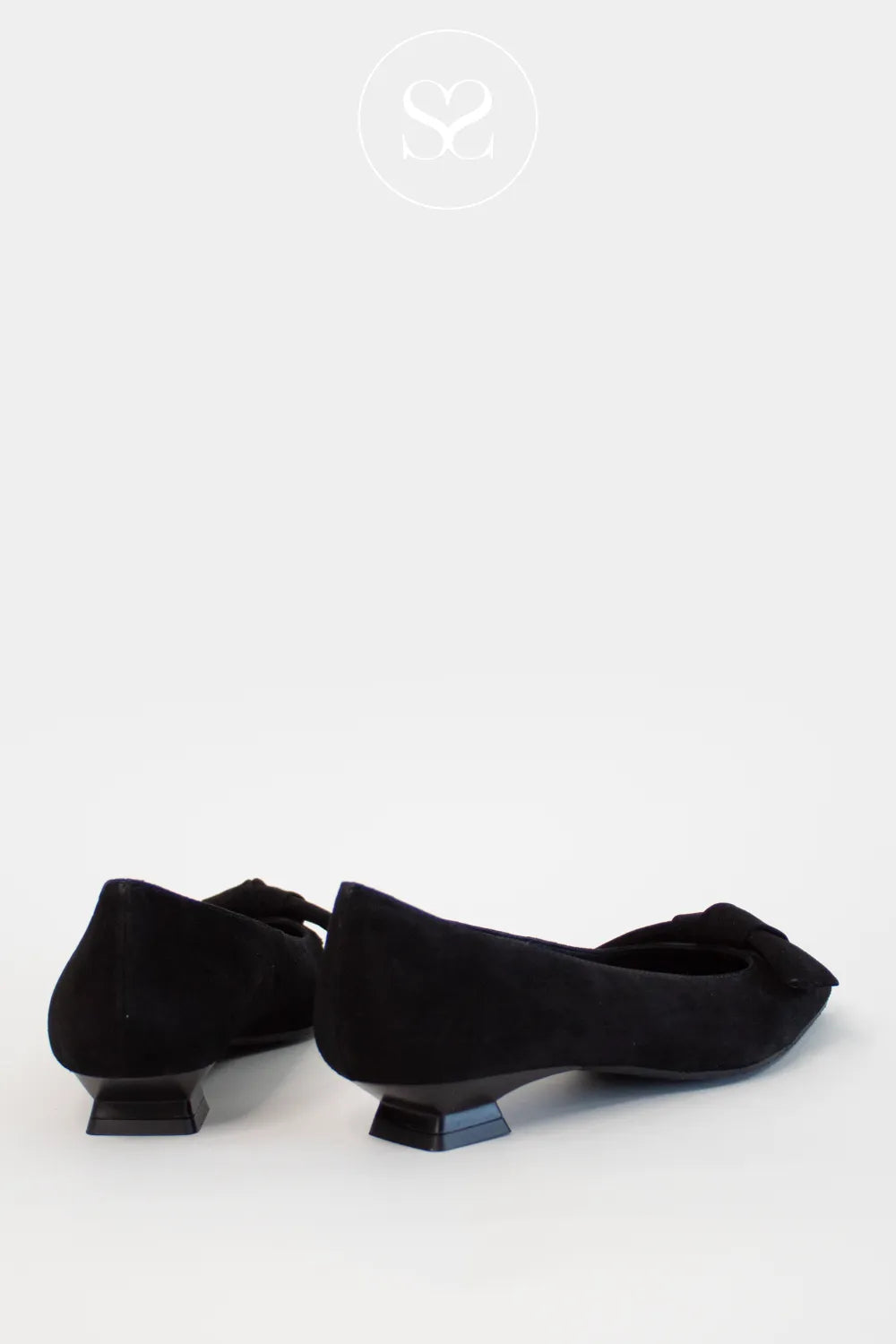 Pair of black suede pointed toe Lodi shoes with bow on a white background