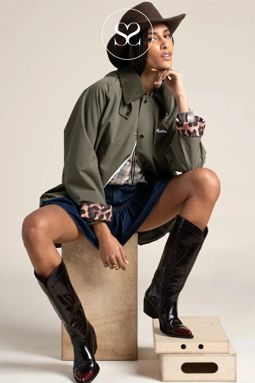 Khaki jacket with cord collar, turned up leopard sleeves and detachable hood