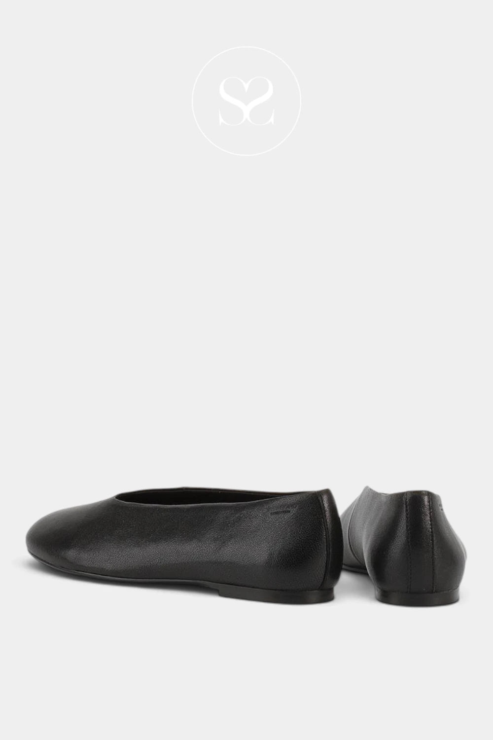 A pair of black leather ballet flats shown from the side and back angles against a light gray background.