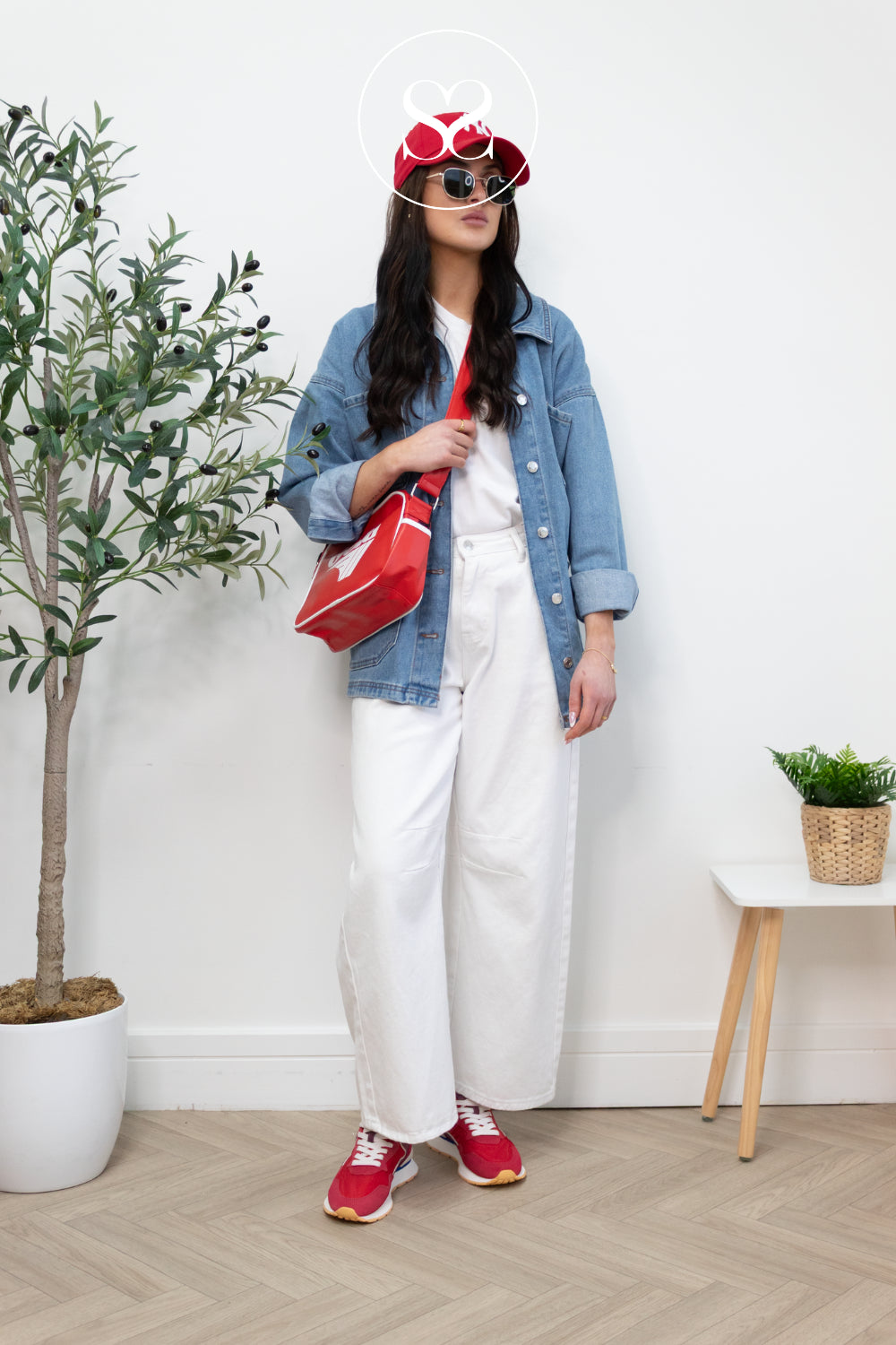 woman wearing casual outfit with gola red bag paired with red HOFF walking trainers