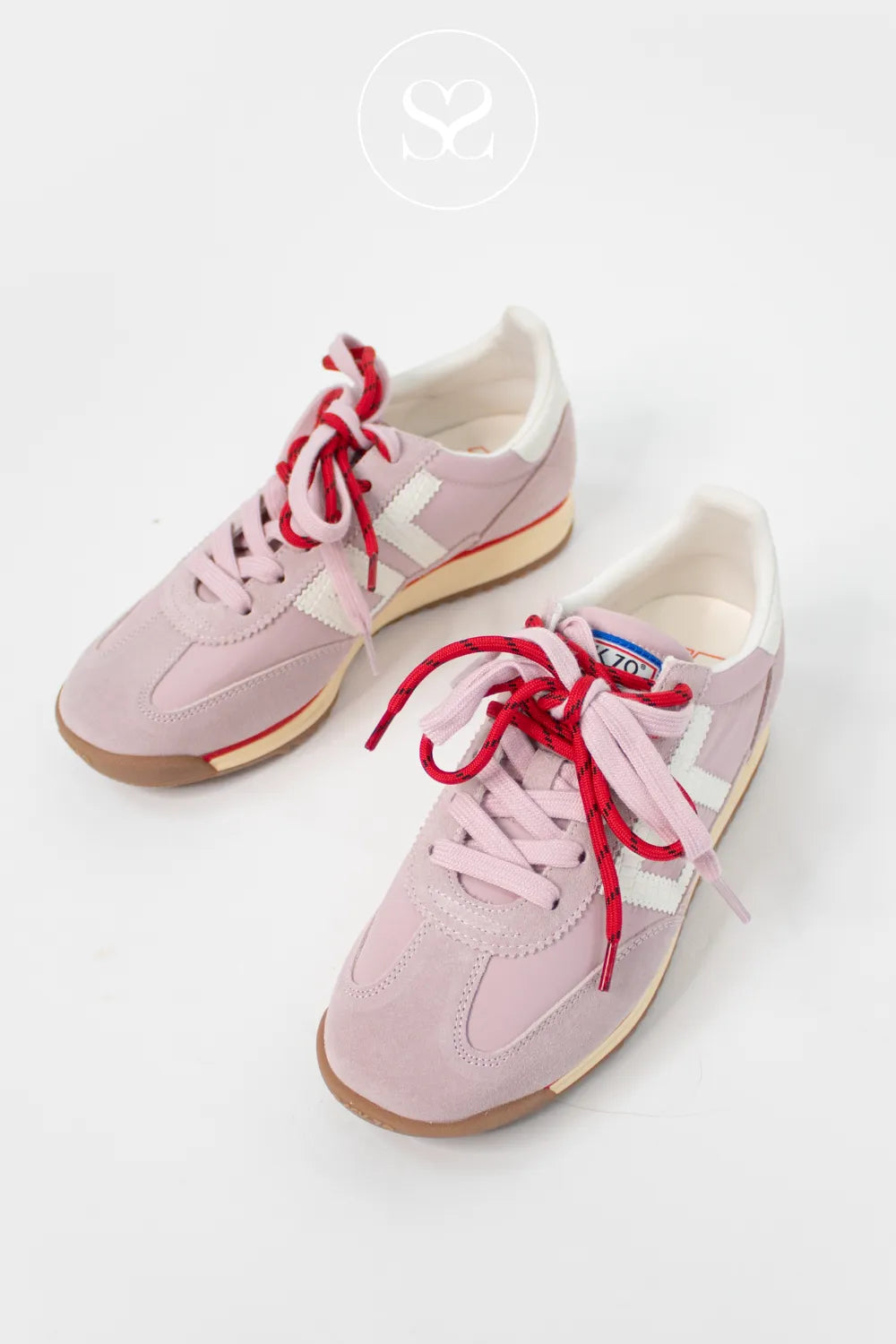 pink sneakers with a pink and red lace, white 70 logo on the side and gum sole