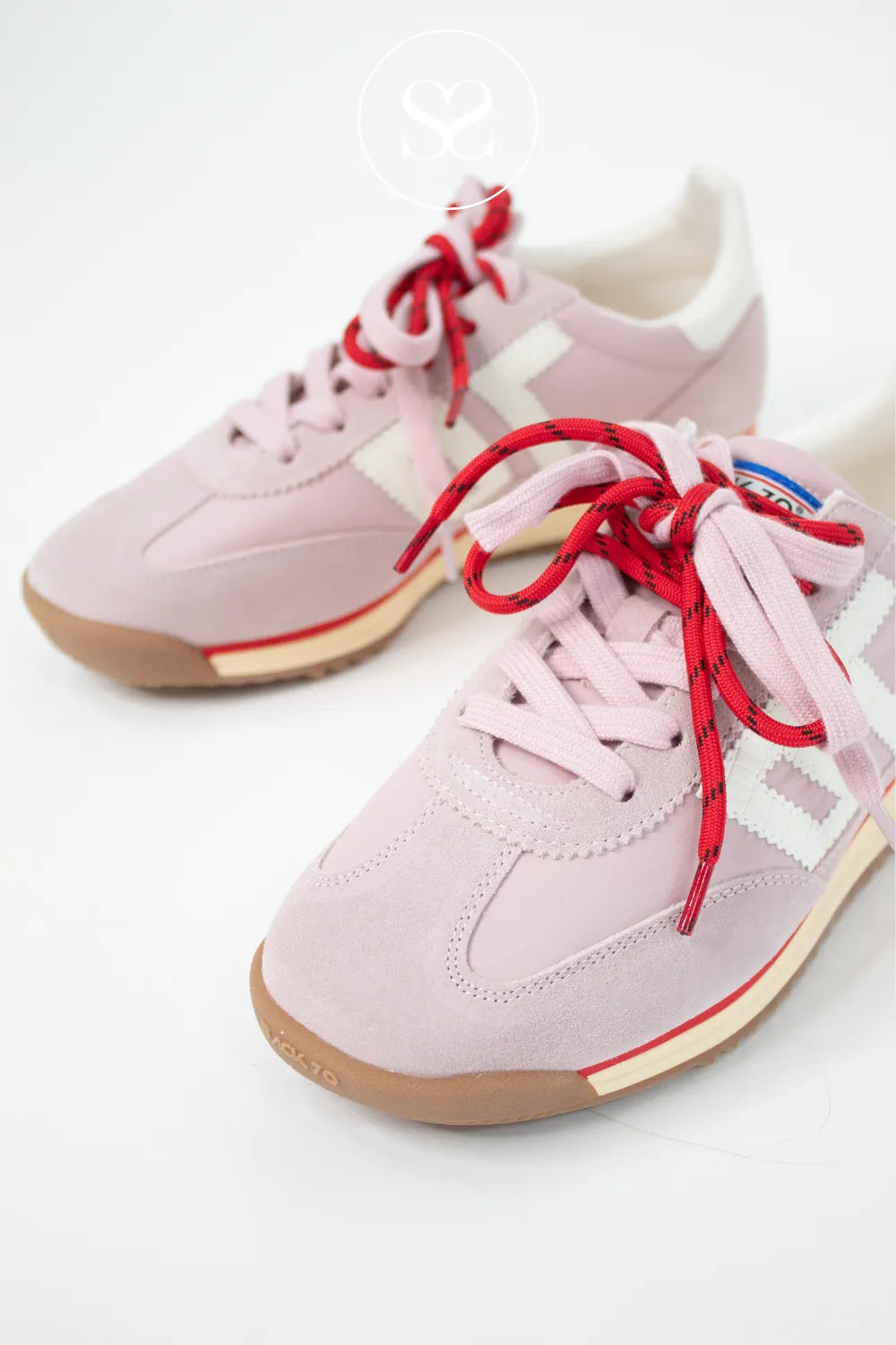 pink suede trainers with double lace, gum sole and white logo on the side.