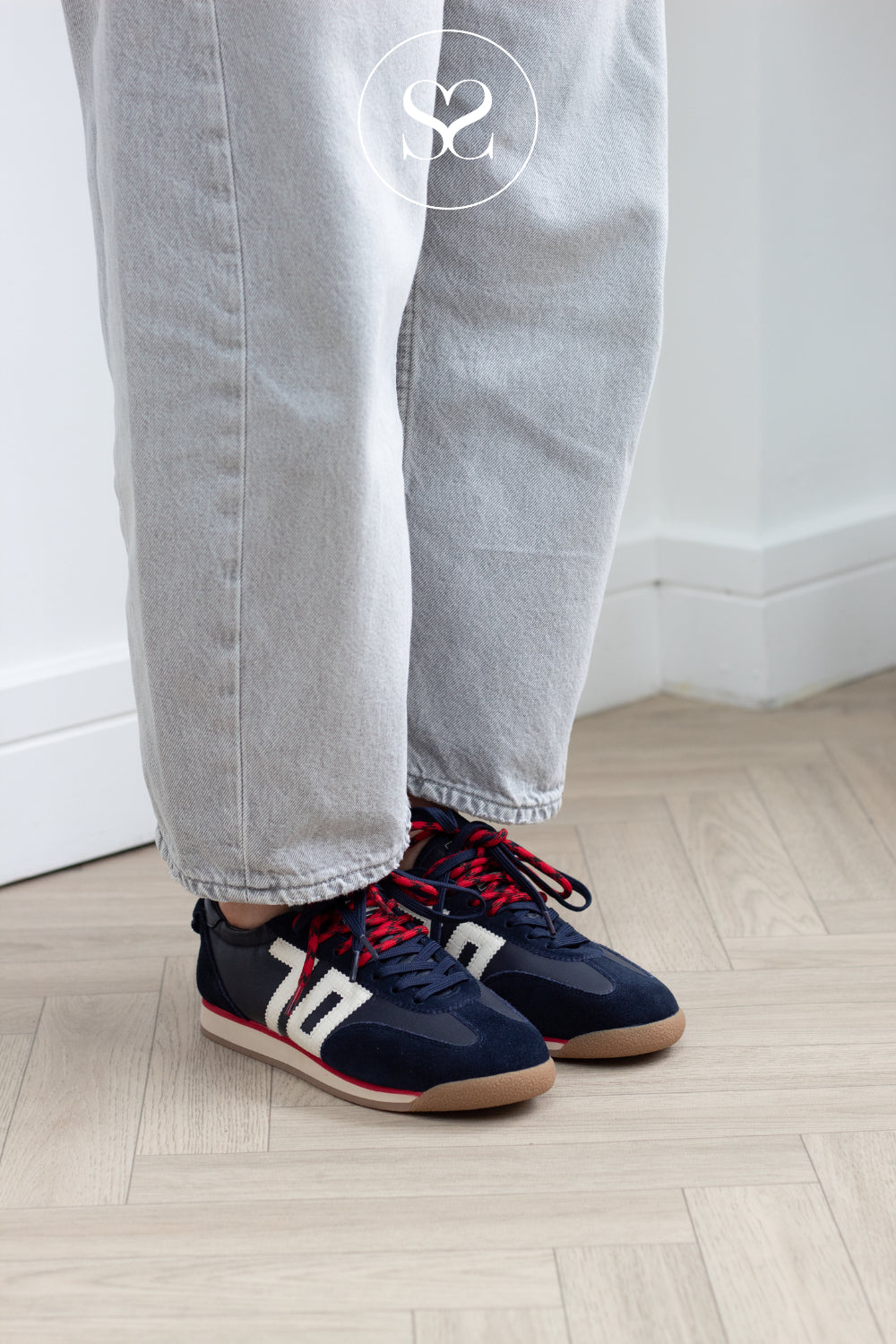 woman wearing navy slimline trainers from back 70 in Ireland