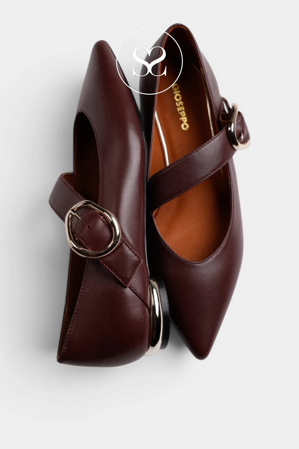 A pair of dark burgundy leather pointed-toe flats with a single strap and a round metal buckle, shown from a top-down angle on a light gray background. The brand name 'ROSSOPO' is visible on the inner sole of the right shoe.