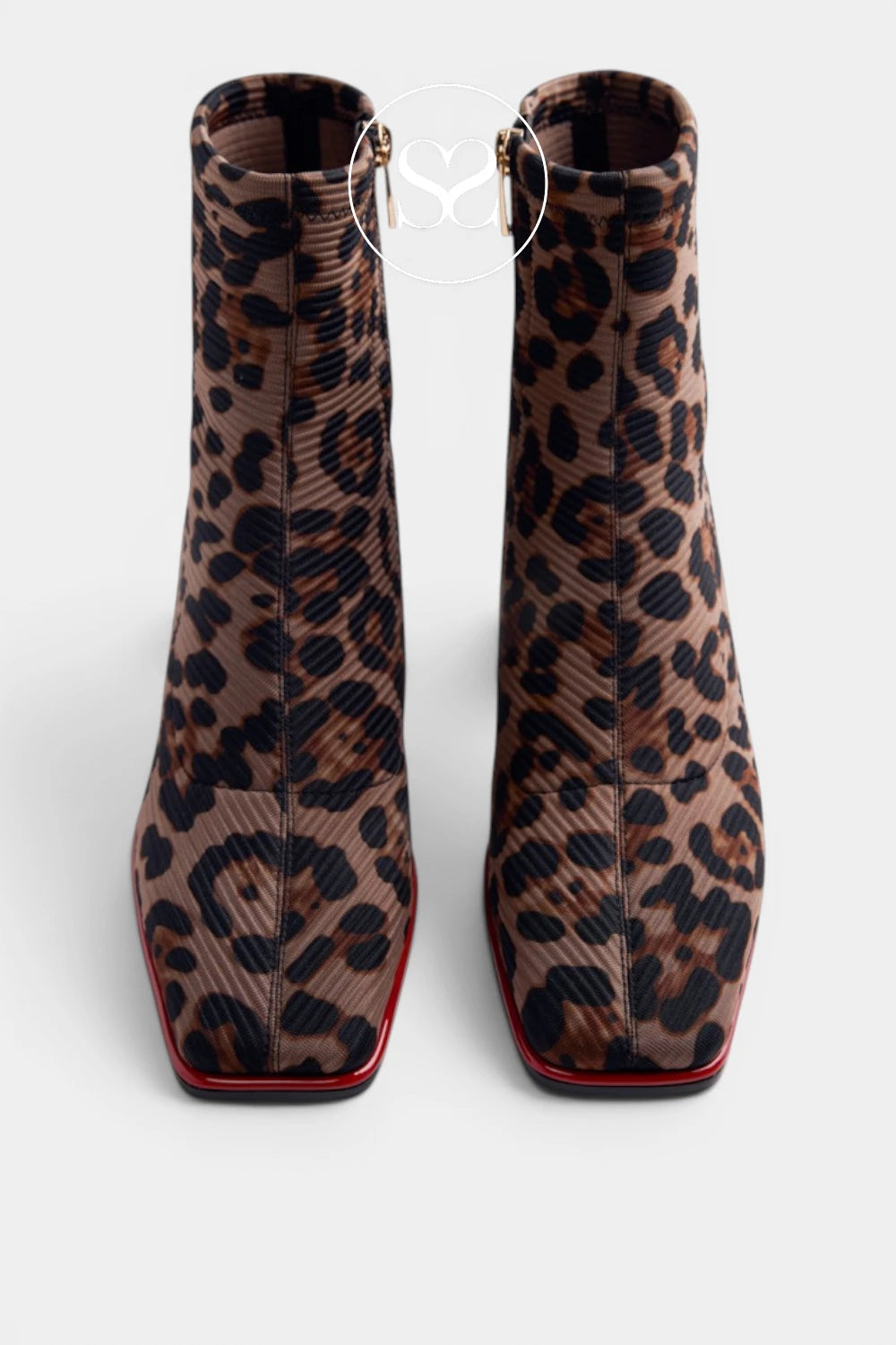 A pair of pointed-toe ankle boots featuring a brown and black leopard print pattern with a thin red sole, shown from a top-down view on a light gray background.