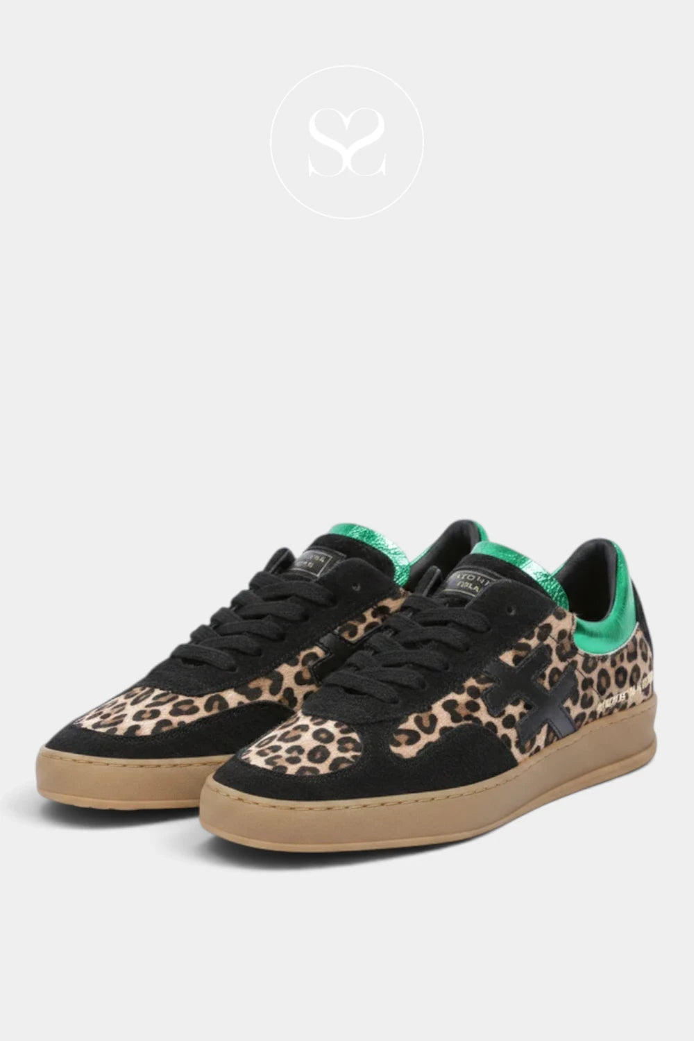 A pair of low-top sneakers from Another Trend featuring a black base with a beige and brown leopard print pattern on the toe and heel, black laces, and a bright green tongue accent, set against a light gray background.