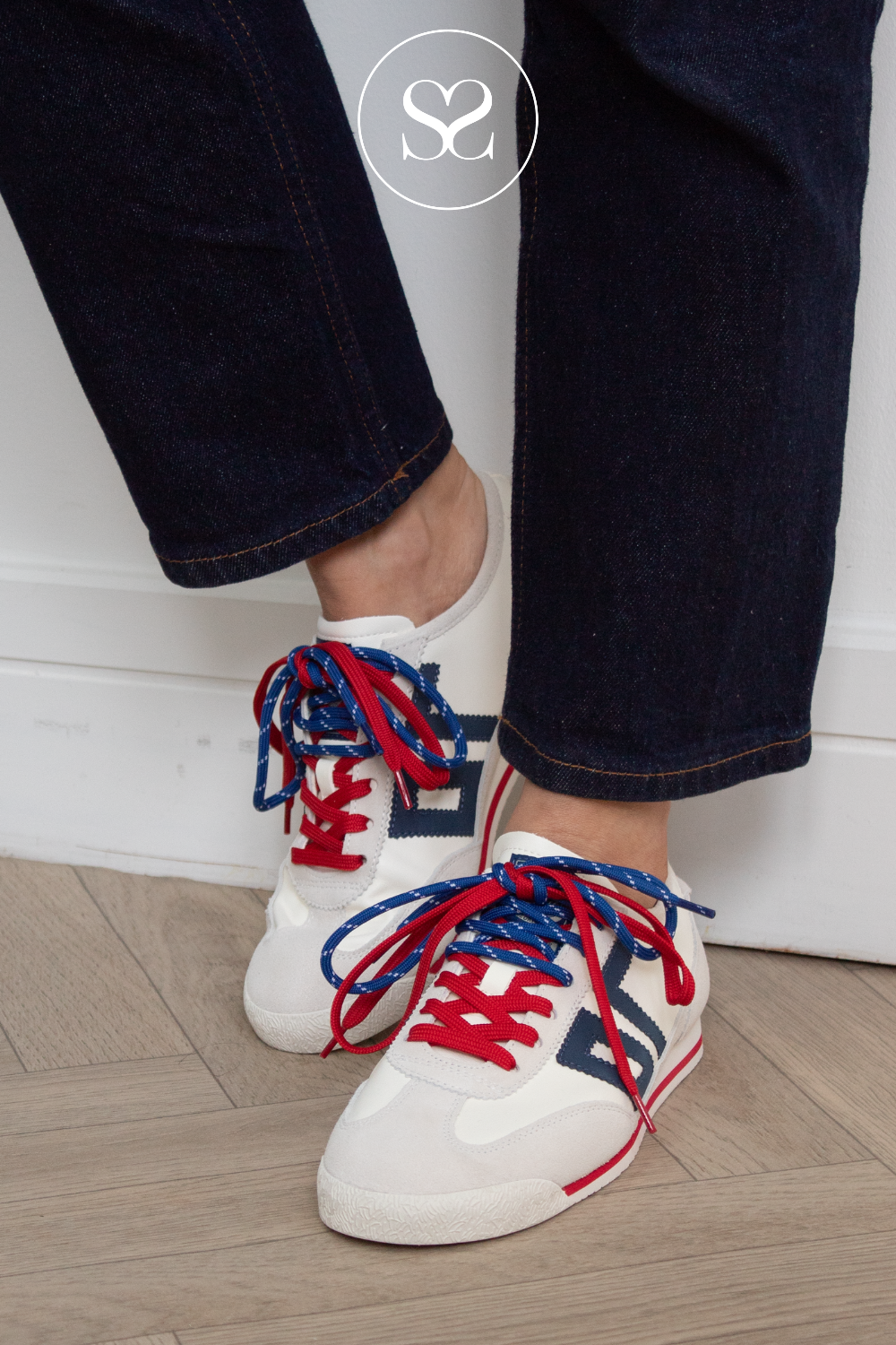 woman wearing white retro trainers with double lace