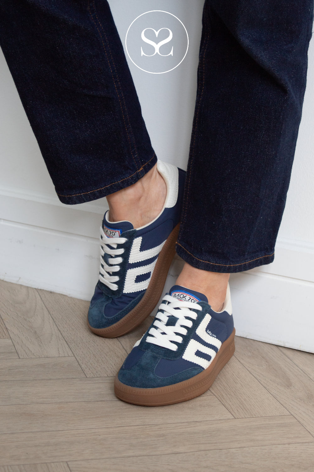 Woman wearing back 70 platform navy trainers in Ireland