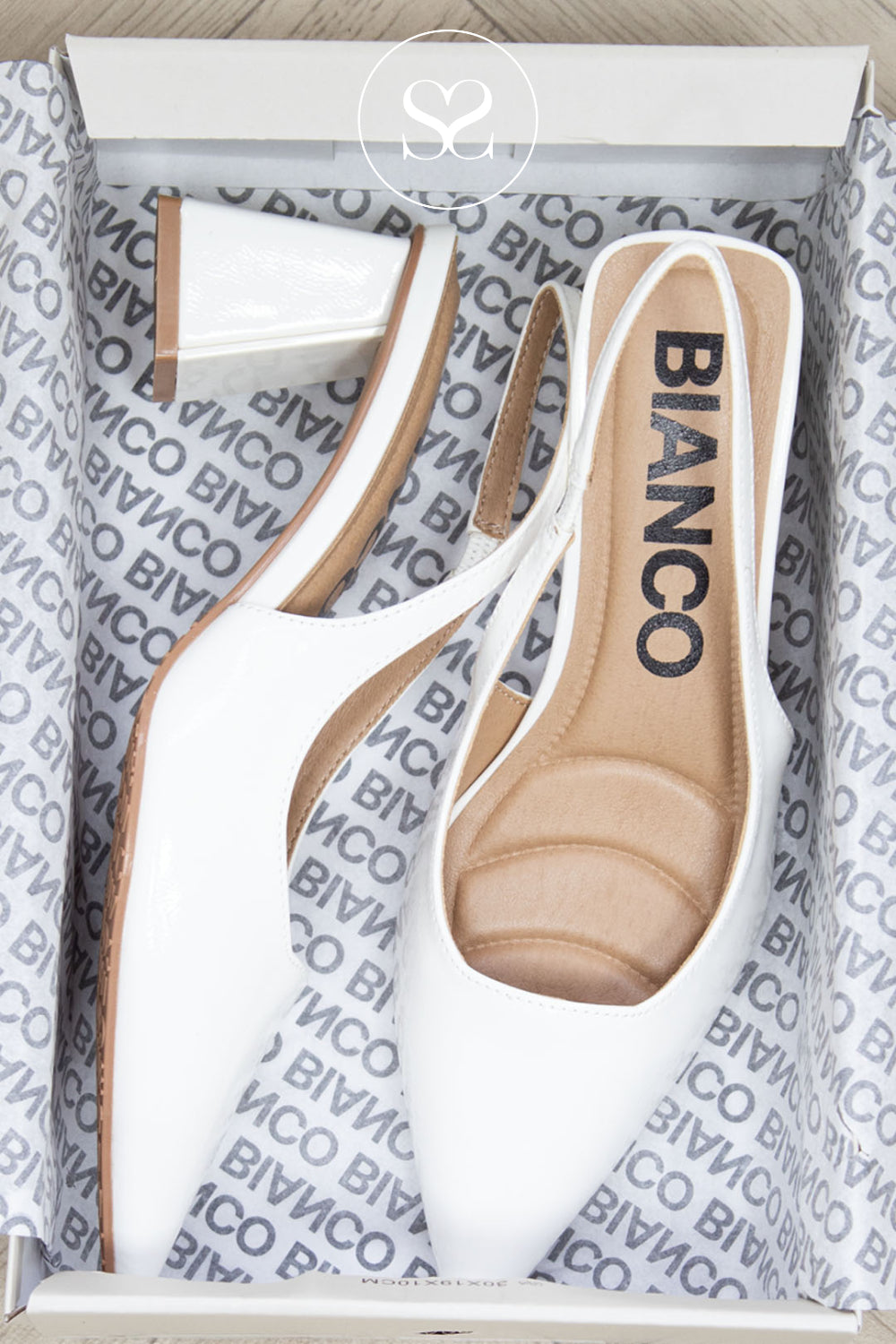 White high-heeled slingback shoes with brown soles in a Bianco branded box.