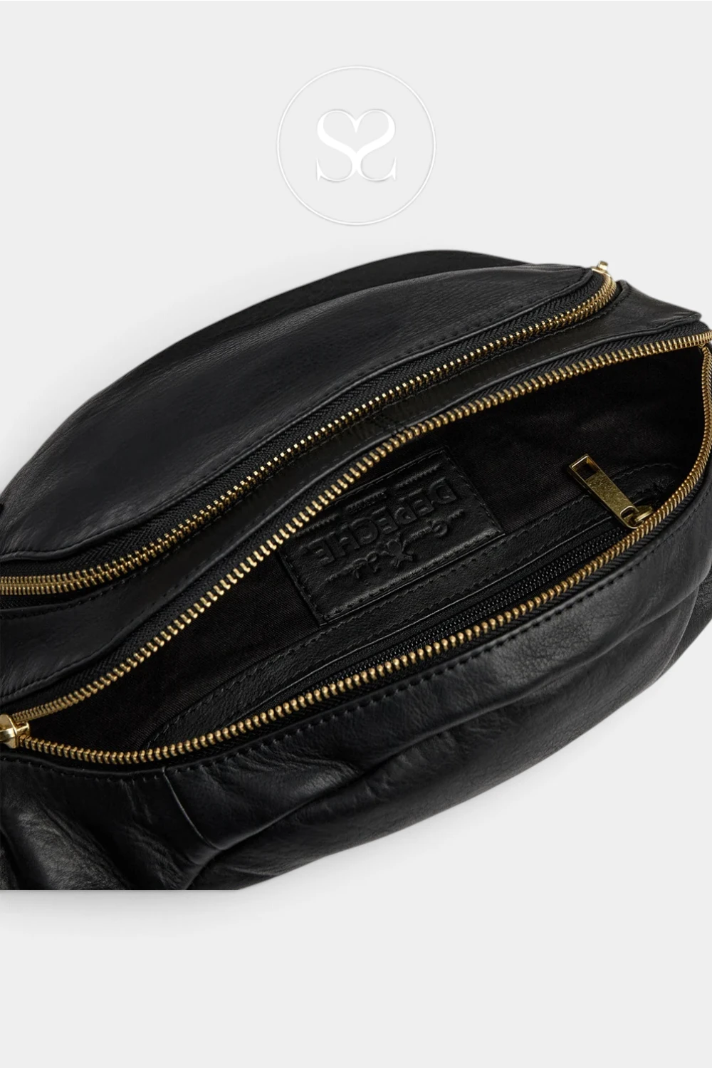 Close-up of a black leather bag with gold-tone zippers, showing the interior lining and a branded leather patch. A faint circular logo watermark appears near the top center.