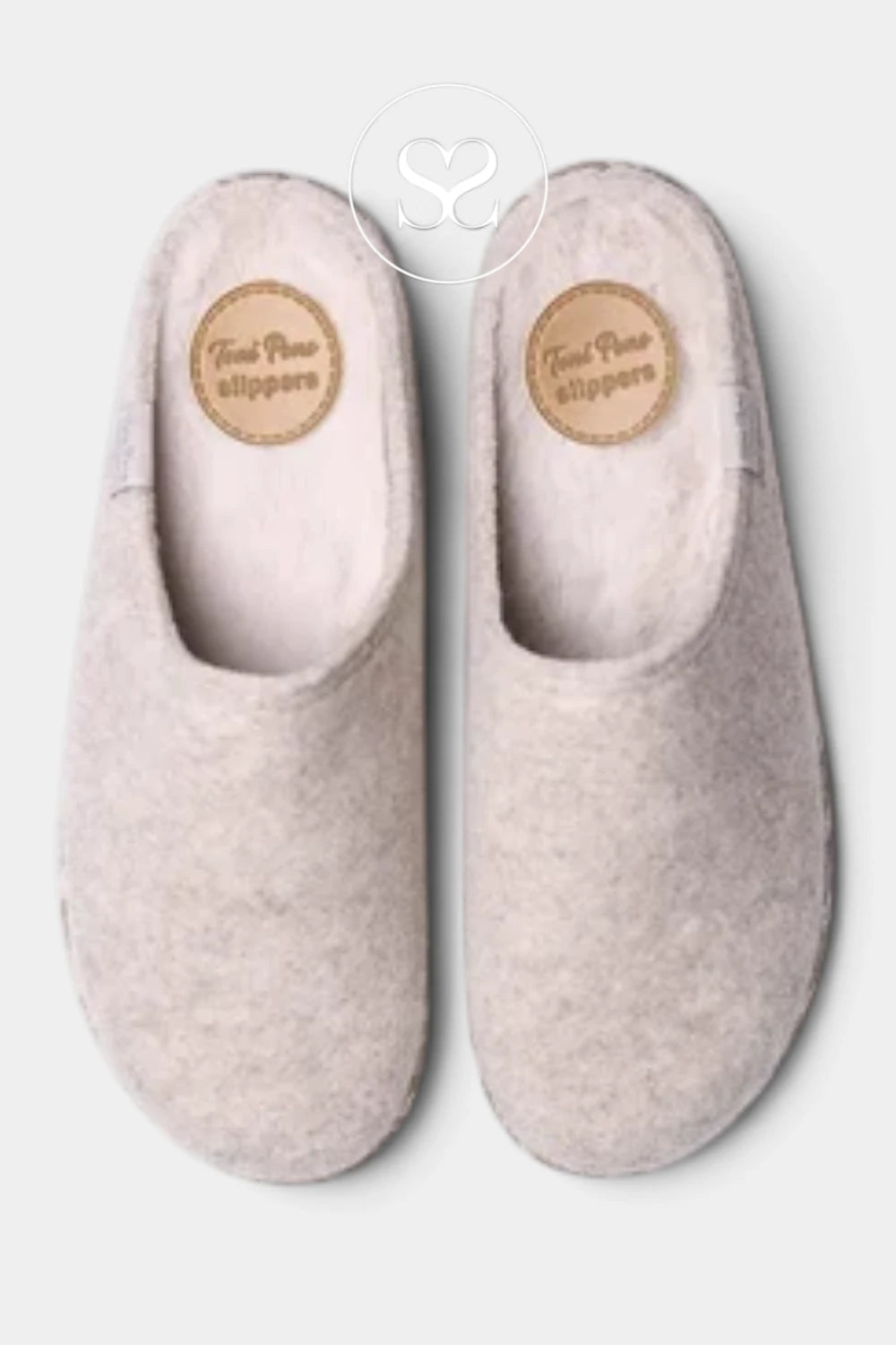 A pair of light beige felt slip-on slippers with a soft lining, shown from a top-down view on a light gray background. A circular brand label reading 'Feet Fine slippers' is visible on the insole of each slipper.