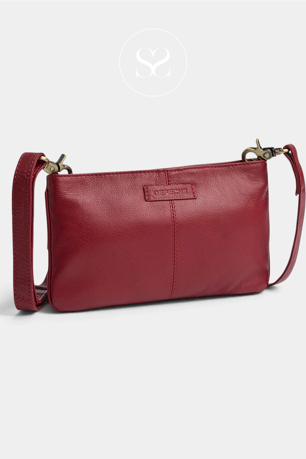 A red leather shoulder bag with a top zipper, gold-tone hardware, and a small brand plaque on the front, shown on a light gray background with a faint circular logo above.