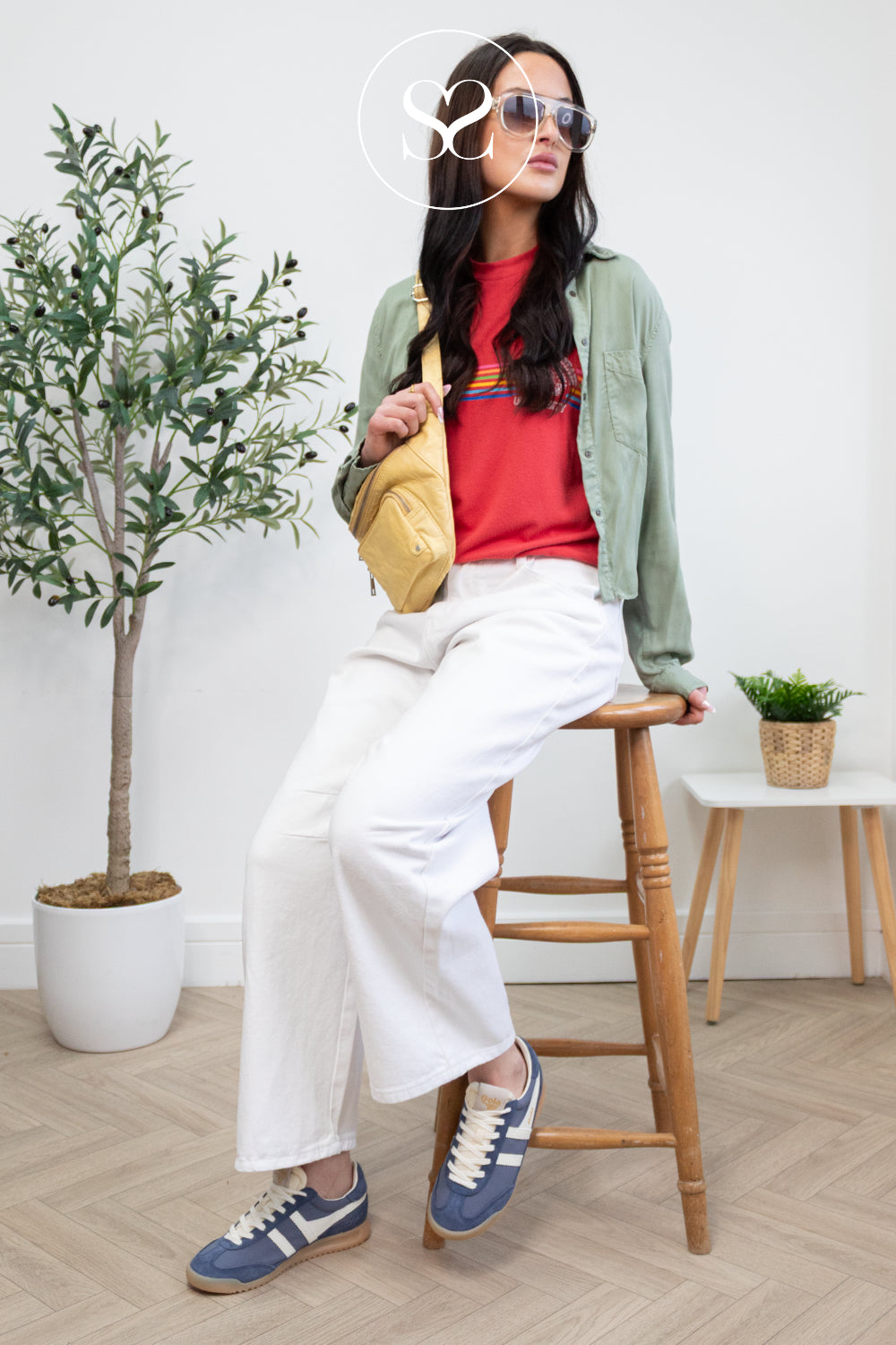 woman wearing cool blue suede trainers from gola with gum sole and white laces