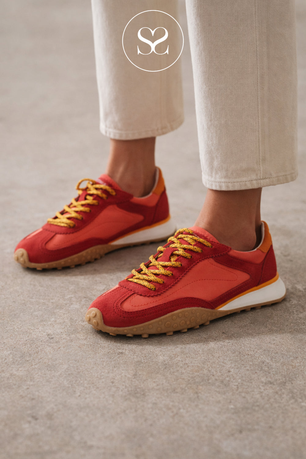 woman wearing hoff bridge trainers in coral red