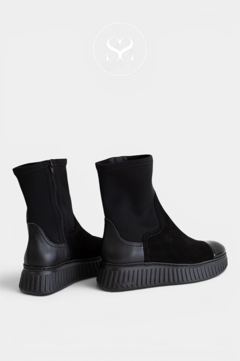 Black sock boots with a patent toe cap, adding a polished contrast to the tonal monochrome design - Ireland