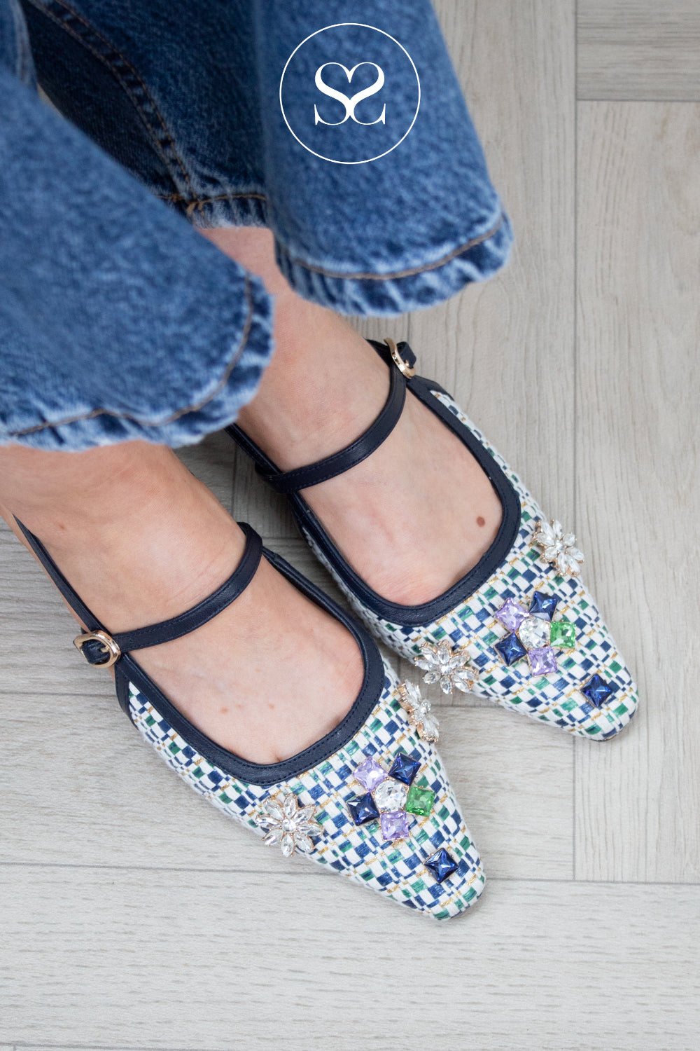 woman wearing jewelled pointed toe slingbacks from lodi in navy woven finish