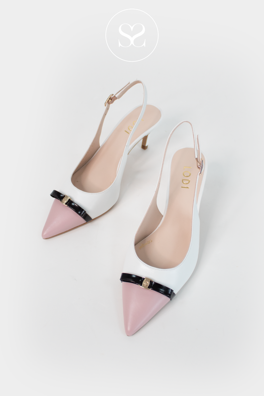 Pair of pink and white high-heeled shoes with slingback. Classic mid heel. Perfect for confirmations and communion season.