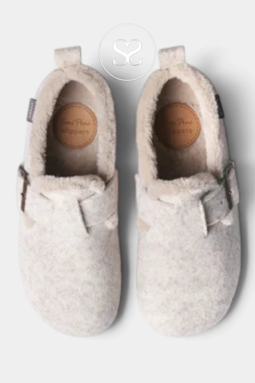 A pair of light beige felt slip-on slippers with soft faux-fur trim and small bow details, shown from a top-down view on a light gray background.